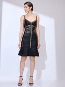 Full body view of woman wearing a bodycon cocktail dress with gold trim, midriff cut-outs, and tiered ruffle mermaid hem.