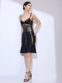 Looking back from a side angle wearing a bandage dress with gold trim and tiered ruffle mermaid hem.