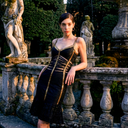 black bandage mini dress with gold trim and ruffle mermaid hem, featuring sweetheart neckline, wide straps, and midriff cut-outs.